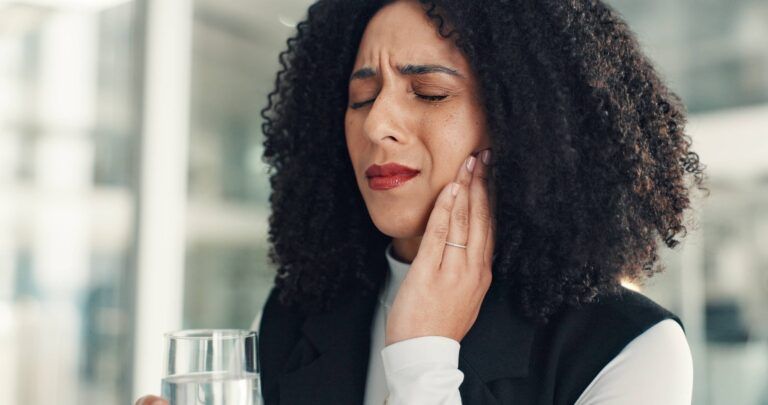 Water, business and woman in office with toothache, oral discomfort or inflammation in mouth